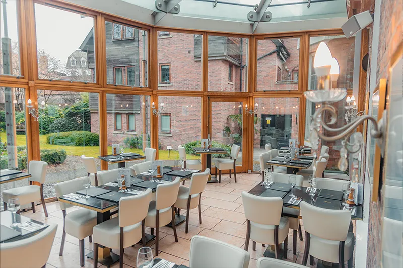 Glass conservatory dining area overlooking the gardens at La Vecchia Scuola York