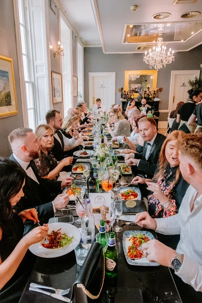 Large group enjoying a shared dining experience at La Vecchia Scuola in York