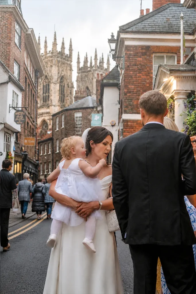 Wedding guests outside La Vecchia Scuola with York Minster in the background